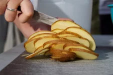 knife-cutting-potatoe-slices.webp